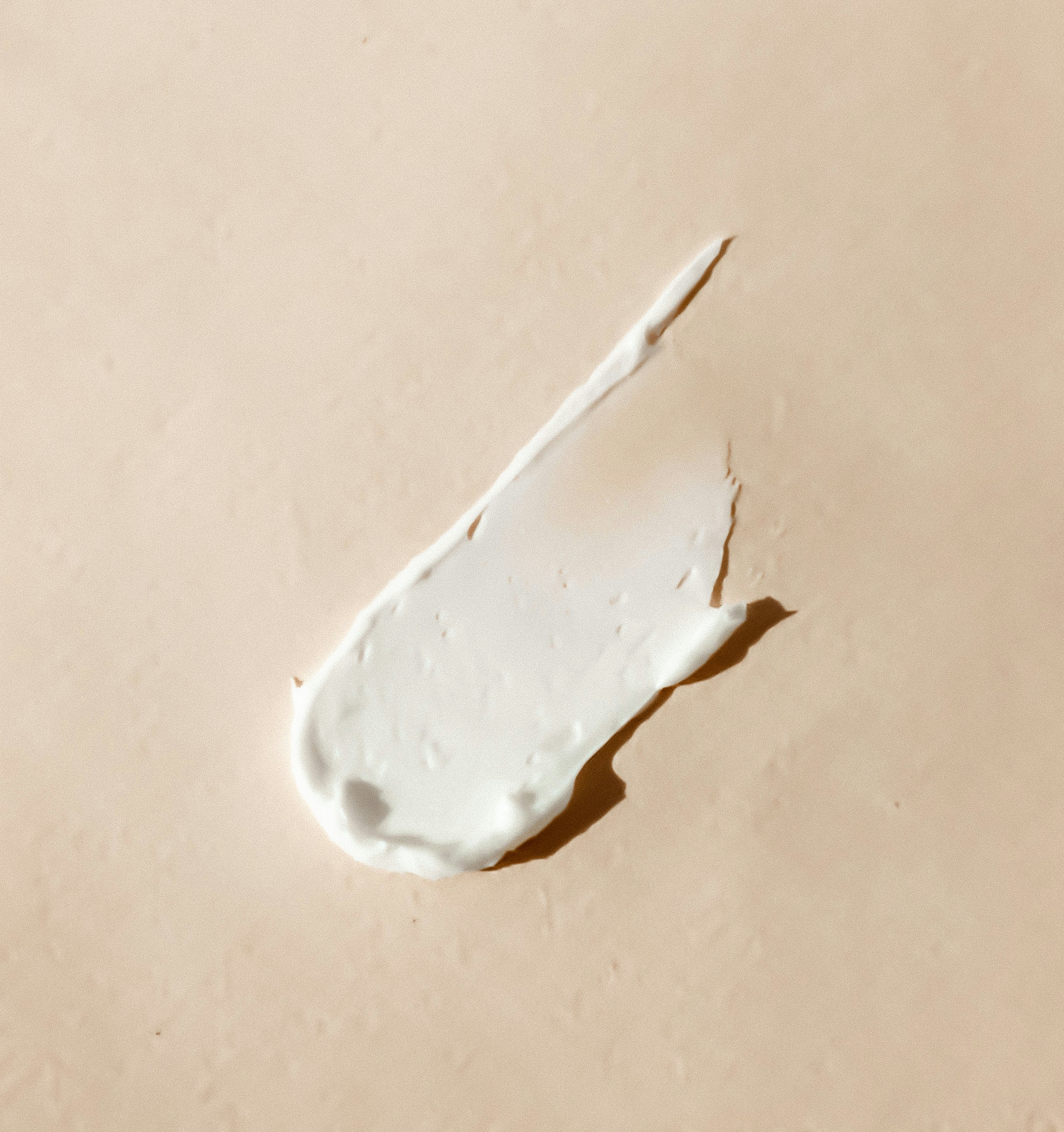 skincare lotion streak on a beige background