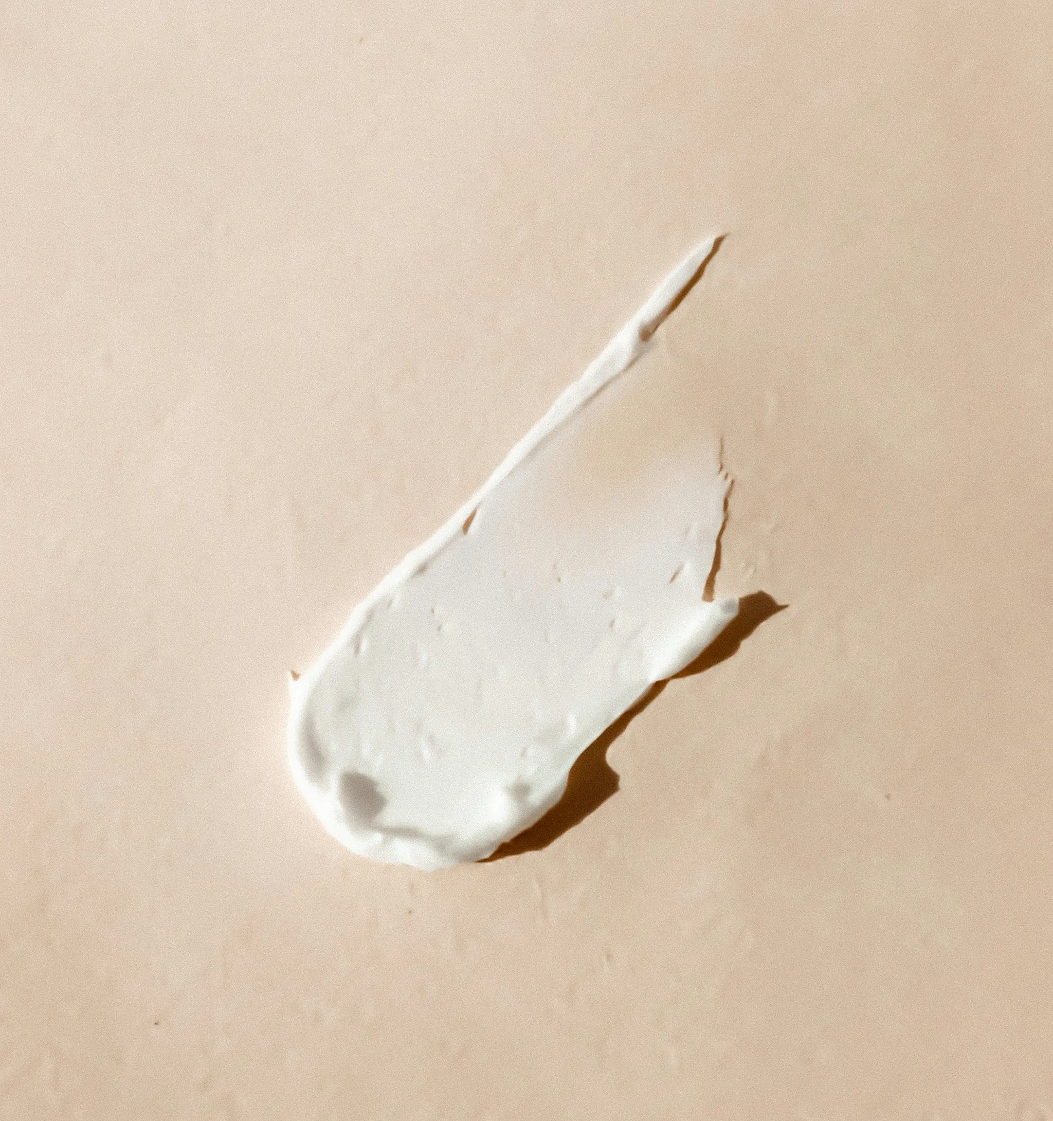 skincare lotion streak on a beige background