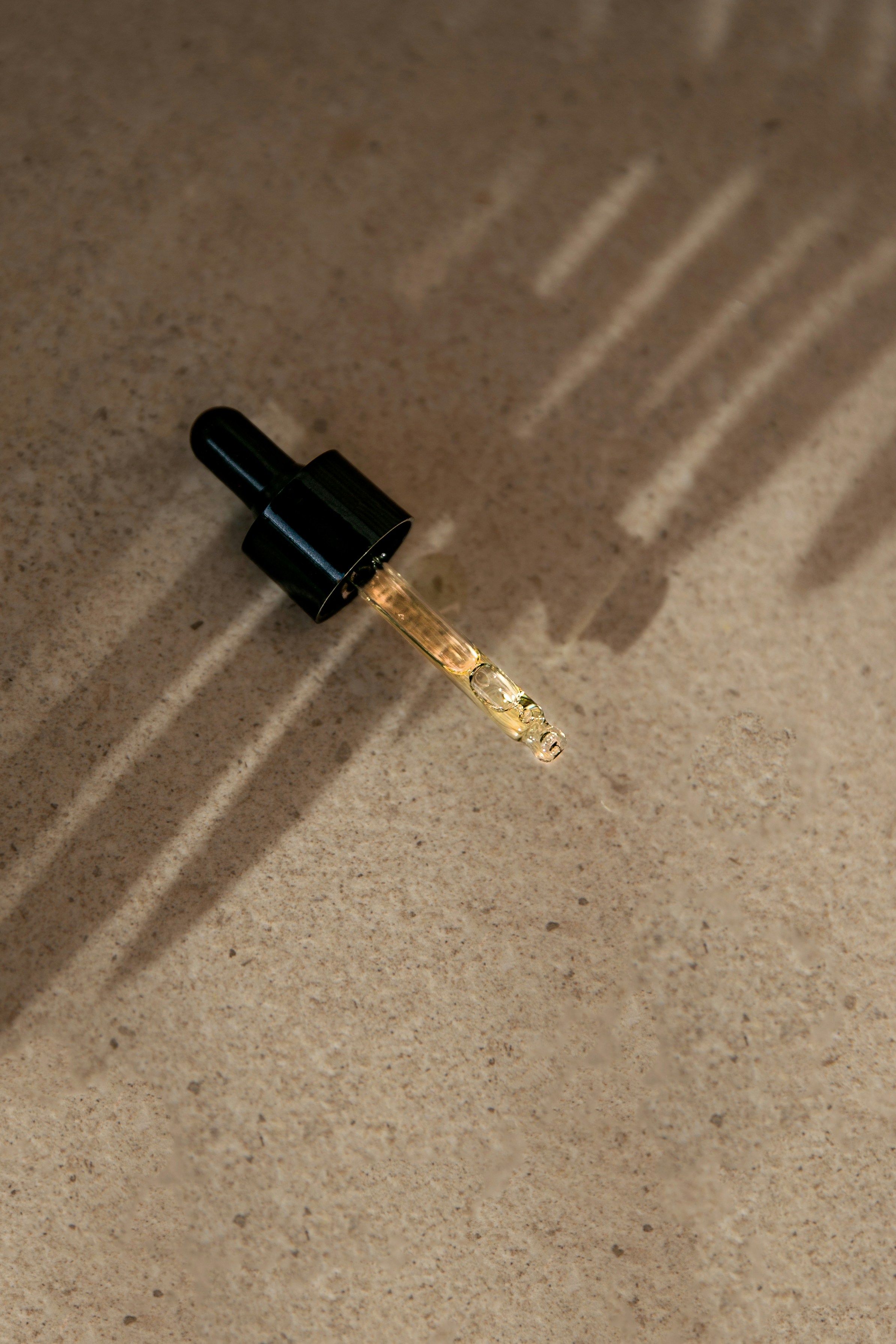 dropper bottle top on rock background