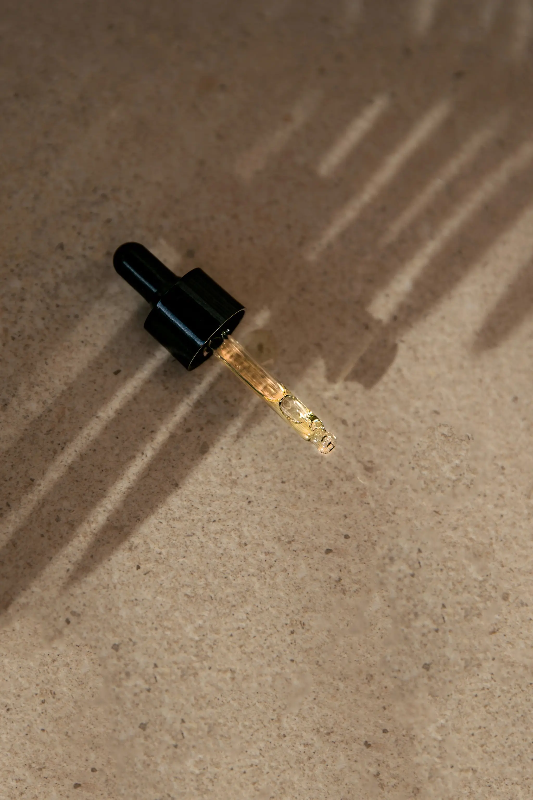 dropper bottle top on rock background